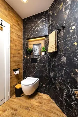 a bathroom with a toilet and a black wall at Apollo Apartment close to Medical University in Plovdiv