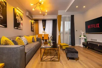a living room with a couch and a television at Apollo Apartment close to Medical University in Plovdiv
