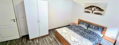 a small bedroom with a bed and a tree picture on the wall at Flower home 10 in Sofia