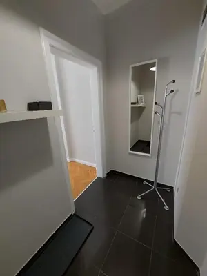 an empty room with a mirror and a hallway at Studio 72 in Sofia