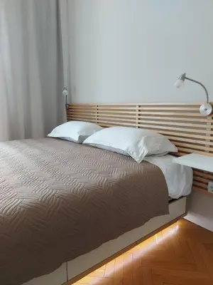 a bedroom with a large bed with white pillows at Studio 72 in Sofia