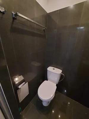 a bathroom with a white toilet and a shower at Studio 72 in Sofia