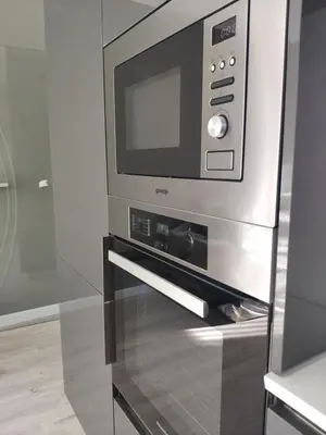 a microwave oven in a kitchen with a glass door at Central, brand new apart with parking in Blagoevgrad