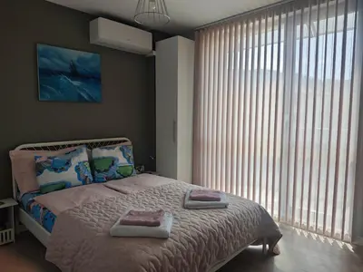 a bedroom with a bed with two towels on it at Central, brand new apart with parking in Blagoevgrad