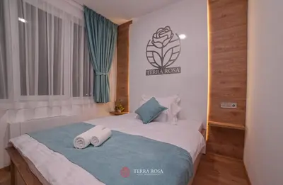 a bedroom with a bed with two towels on it at Хотел Терра Роза in Karlovo