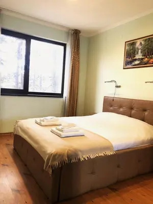 a bedroom with a bed with two towels on it at Апартамент Веирас in Velingrad