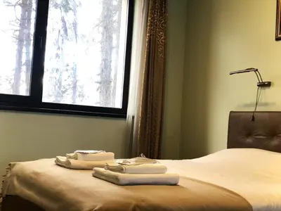 a bedroom with a bed with two towels on it at Апартамент Веирас in Velingrad