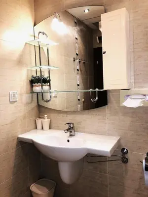a bathroom with a sink and a mirror at Апартамент Веирас in Velingrad