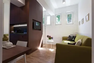 a living room with a green couch and a table at Gorgeous apartment in the perfect area in Sofia