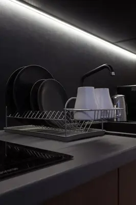 a kitchen counter with a dish drying rack and a sink at Gorgeous apartment in the perfect area in Sofia