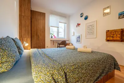 a bedroom with a large bed and a window at 1 Bedroom Natural Condo in Sofia