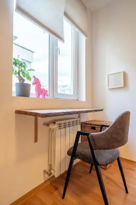 a desk and a chair in a room with a window at 1 Bedroom Natural Condo in Sofia