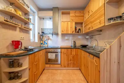 a kitchen with wooden cabinets and a sink at 1 Bedroom Natural Condo in Sofia
