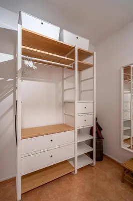 a closet with white drawers and shelves at 1 Bedroom Natural Condo in Sofia