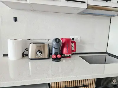 a kitchen counter with a coffee maker and a toaster at Boutique Studio B37 in Borovets