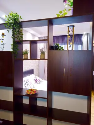 a room with a bed and a cabinet with plants at 
