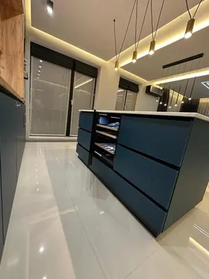a kitchen with a blue counter and some windows at Regatta Park 2BR Exclusive Suite Parking Included in Plovdiv