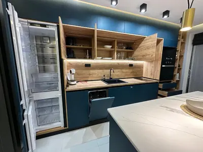 a kitchen with blue cabinets and an open refrigerator at Regatta Park 2BR Exclusive Suite Parking Included in Plovdiv