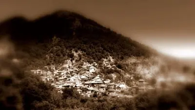 a small town on a hill with a mountain at Шапкова Къща in Delchevo