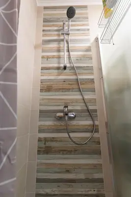 a shower in a bathroom with a tile floor at Apartment KALINA with free private parking in Plovdiv