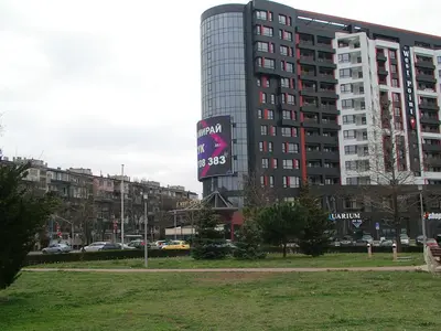 a tall building with a sign in front of it at Apartment KALINA with free private parking in Plovdiv