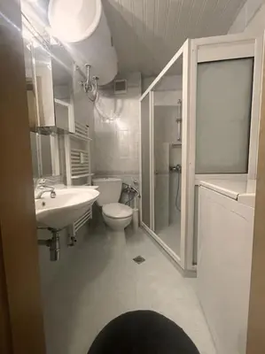 a bathroom with a toilet and a sink and a shower at A Colorful Apart for a Start in Sofia