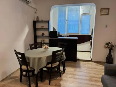 a dining room with a table and chairs and a kitchen at Zoev in Plovdiv