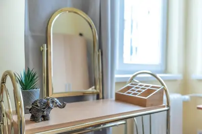 a small elephant sitting on a table in front of a mirror at Two Homelike Apartments by NDK and Vitosha Blvd with 2 Free Parking Spots in Sofia
