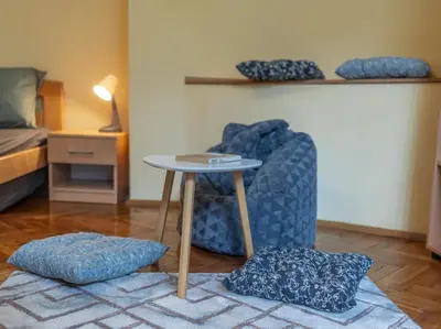 a room with a table and a chair and a bed at Two Homelike Apartments by NDK and Vitosha Blvd with 2 Free Parking Spots in Sofia