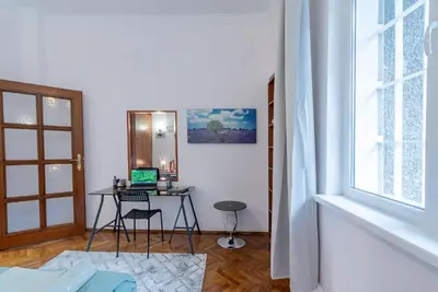 a room with a desk with a laptop on it at Two Homelike Apartments by NDK and Vitosha Blvd with 2 Free Parking Spots in Sofia