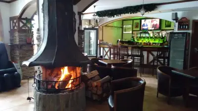 a fireplace in a restaurant with a bar at The Castle Complex - Apartment 401 in Pamporovo