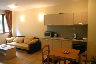 a small living room with a couch and a kitchen at The Castle Complex - Apartment 401 in Pamporovo