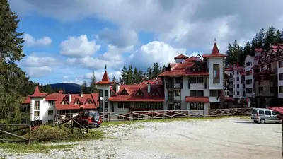 a group of buildings with red roofs at The Castle Complex - Apartment 401 in Pamporovo