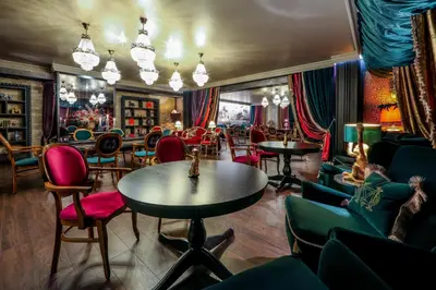 a bar with chairs and tables in a room at Complex Baroto in Gotse Delchev