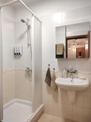 a white bathroom with a sink and a shower at apartment Mountain Delight, Bansko in Bansko