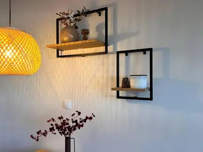 a wall with two shelves and a vase with flowers at Cozy 1 bedroom apartment next to the gondola in Bansko