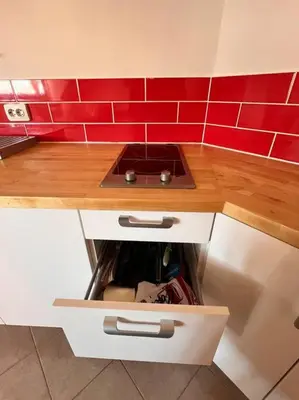 a kitchen with a sink and red tiles at Cozy 1 bedroom apartment next to the gondola in Bansko