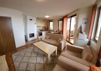 a living room with two couches and a table at Gri's place in Bansko