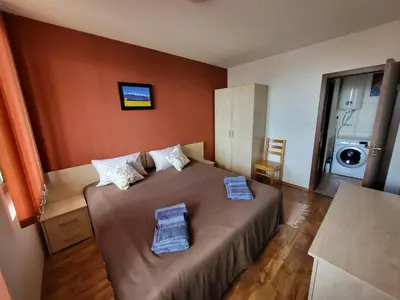 a bedroom with a bed with two towels on it at Gri's place in Bansko