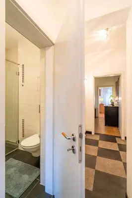 a bathroom with a toilet and a door at Opera in Sofia