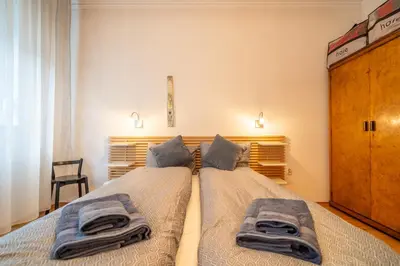 a bedroom with two beds with towels on them at Opera in Sofia