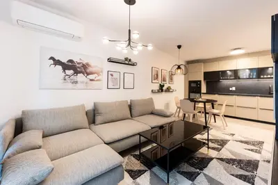 a living room with a couch and a table at Central View Apartment 1 in Blagoevgrad