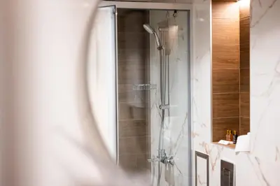 a shower in a bathroom with a mirror at Central View Apartment 1 in Blagoevgrad