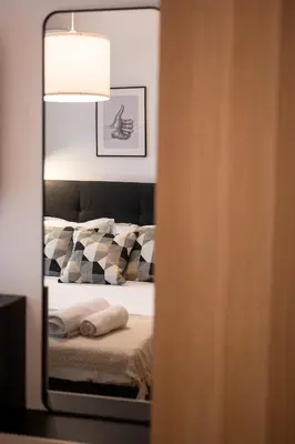 a mirror reflection of a bed in a bedroom at Central View Apartment 1 in Blagoevgrad