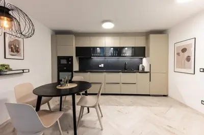 a kitchen and dining room with a table and chairs at Central View Apartment 1 in Blagoevgrad