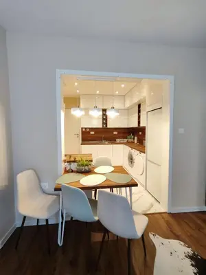 a dining room with a table and chairs and a kitchen at The Modern Suite Life with Terrace in Sofia