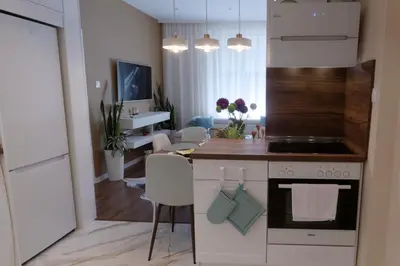 a kitchen with a counter and a dining room at The Modern Suite Life with Terrace in Sofia