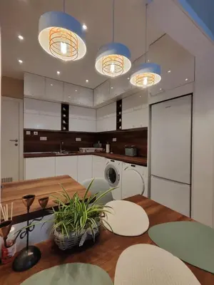 a kitchen with a wooden table and blue lights at The Modern Suite Life with Terrace in Sofia