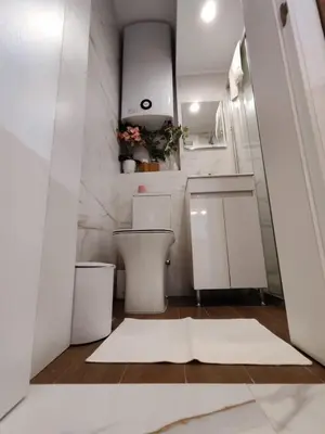 a white bathroom with a toilet and a sink at The Modern Suite Life with Terrace in Sofia