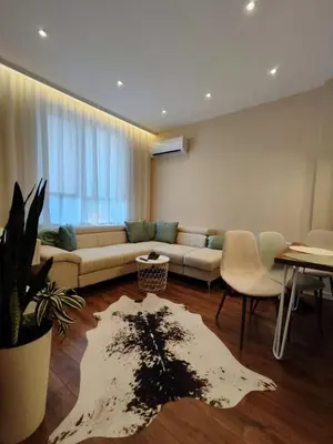 a living room with a couch and a table at The Modern Suite Life with Terrace in Sofia